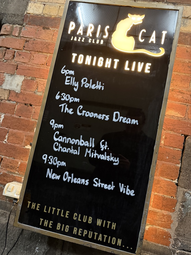 Paris Cat Jazz Club sign listing The Crooners Dream on the night's live music lineup